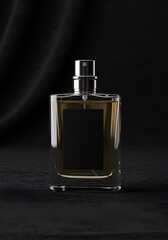 Amber perfume bottle on dark fabric
