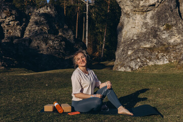 Fit sporty happy young woman wearing sportswear meditating doing yoga breathing stretching...