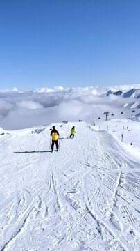 Happy family with children, school kids in winter ski resort, skiing winter time