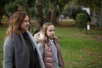 Fototapeta premium Happy family having fun in park. Mother and daughter portrait