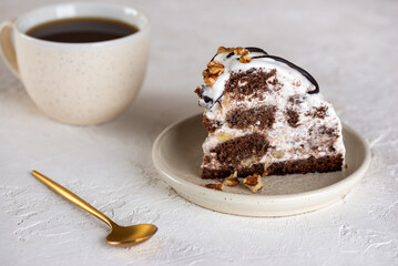 Piece of Pancho cake with pineapple and sour cream topped with chocolate and walnut and cup of coffee on a table. Vegan dessert. Sugar, lactose and gluten free.