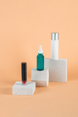Plastic white tube for cream or lotion. Skin care or sunscreen cosmetic with stylish props on cream background.