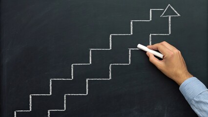 Hand drawing chalk steps with arrow on blackboard represents progress and success