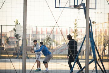 Group of friends playing basketball outdoors