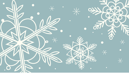 Delicate white snowflakes scattered across a light blue winter backdrop creating a festive scene for winter