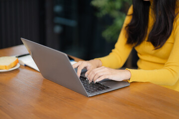 Fototapeta premium Women are using a Laptop computer playing social media and laptop wifi connection, home office workplace lifestyle people..