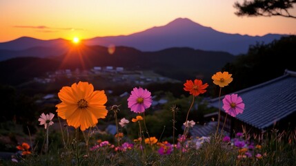 Obraz premium Beautiful colorful flowers blooming against a majestic mountain sunset