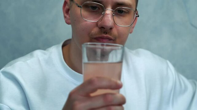 Medicinal drink in a glass.
Antiviral powder diluted in water.
Proportion of water and medicine.
Close-up of a medical preparation in a glass