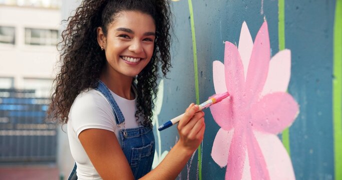 Painting, mural and portrait of woman with wall for art design, creative project and community service. Artist, volunteer and person with paintbrush for flower decor, inspiration or DIY hobby in city