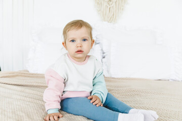 Fototapeta premium baby 6-12 months smiling and sitting on bed