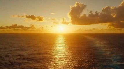 Fototapeta premium Golden sunset over a vast ocean expanse.