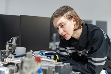 Assembling computer hardware. Engineer assembling circuit board in technology lab. Engineer...