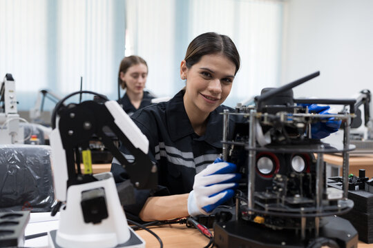 Assembling Robotic Arm. Engineer training and test programmable logic controller with AI robot training kit and mechatronics engineering in workshop