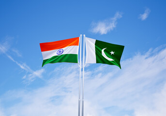 flags of pakistan and india over blue sky background.