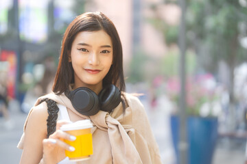 Portrait of southeast asian woman gen z wearing headphones eye looking at camera