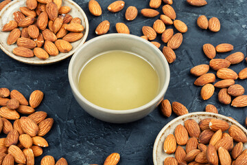 Almond oil with shelled almond nuts.