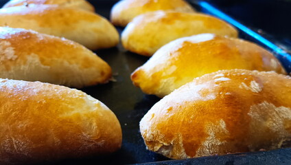 The finished hot golden pies lie after the oven