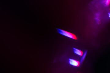 Colorful light leak on black background, abstract design with optical lens flare shot on a long lens