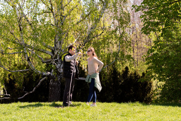 Capturing Moments in Nature A Sunny Afternoon Encounter Between Two Individuals in a Green Landscape