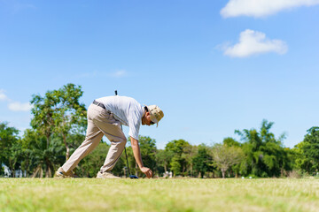 An Asian amateur golfer is enjoy playing golf in golf country club.