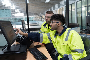 Machine learning. Electrical engineer. Works on desktop computer. Team of male engineers training...