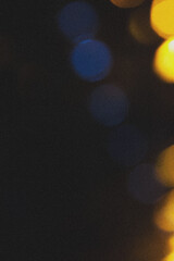 Gold yellow light abstract bokeh on black background.