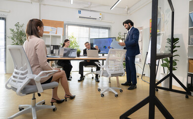 In a contemporary office, a group of senior executives with a mission to approve new projects and monitor the progress of business projects