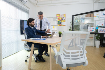 In a contemporary office, two senior executives with a mission to brainstorm and monitor the progress of a business project