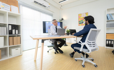 In a contemporary office, two senior executives with a mission to brainstorm and monitor the progress of a business project