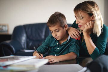 Fototapeta premium Mother and her son doing homework together