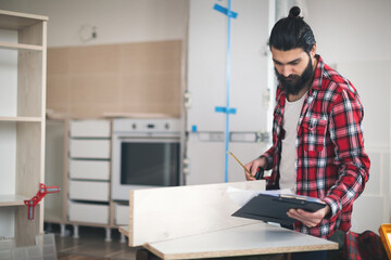 Young man making his own furniture at home