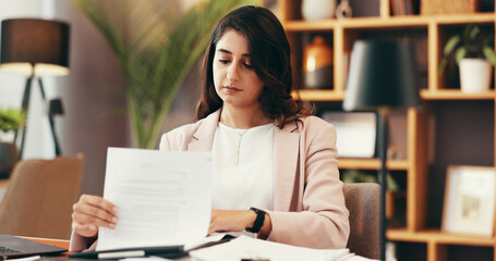 Fototapeta premium Reading, paperwork and business woman in office with accounting budget, bookkeeping and finance report. Auditor, check document and serious employee with revenue, tax invoice and payroll information