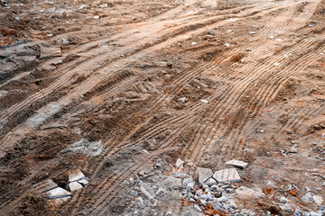 Tire Tracks on Brown Dirt Ground Construction Site Showing Heavy Machinery Vehicle Movement