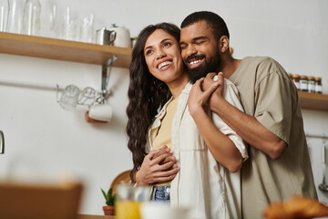 Romantic evening at home with a loving couple sharing a cozy moment in their kitchen