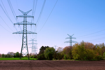 High voltage power lines in the field. Iron pole with cables, wires with electricity in the sky....