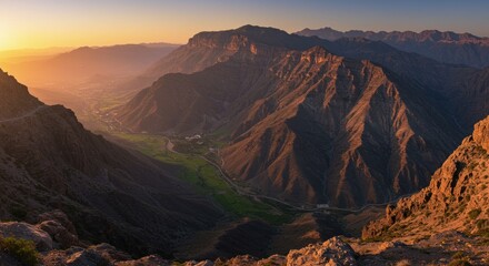 Fototapeta premium Sunrise Over Majestic Mountain Range with Green Valley in Arab