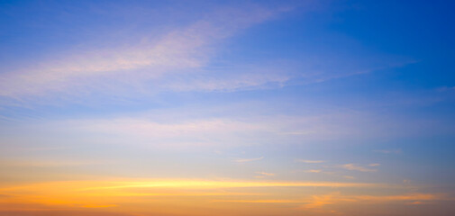 Sunset sky background with summer natural yellow golden light and cloud on blue panoramic evening sky backdrop
