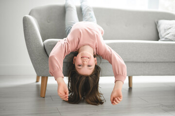 Portrait of a cute 8 years old girl on sofa at home