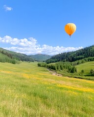 Fototapeta premium A vibrant orange hot air balloon floats serenely over a sun-drenched valley, wildflowers carpeting the meadow below, mountains rising in the distance under a clear blue sky