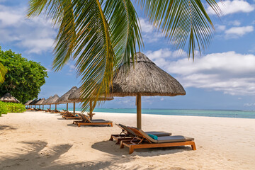Idyllic Tropical Vacation Spot: Palm-Fringed Beach with Wooden Loungers and Palapas.Serene Beach Escape with Straw Umbrellas and Sunbeds under Clear Blue Skies