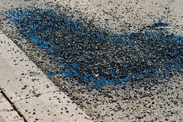 Asphalt crack sealing with bitumen, gravel and resin material during street repair, urban maintenance work for long-term road surface protection. Bitumen and gravel mix for repair asphalt road