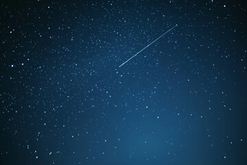 A shooting star streaks across a tranquil night sky filled with a myriad of sparkling stars.