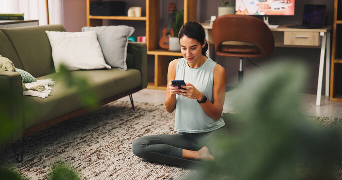 Woman, smartphone and smile with exercise break in house, influencer and social media comment response. Mobile app, email or fitness blog with positive review, post communication or workout chat