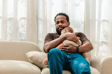 Obraz premium Loving Black Father Holding Baby.