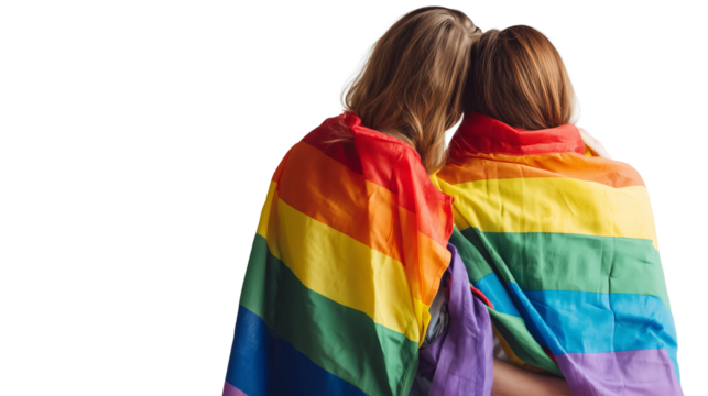 Two women embrace under a rainbow flag, celebrating love and unity at a pride event in a vibrant, welcoming atmosphere