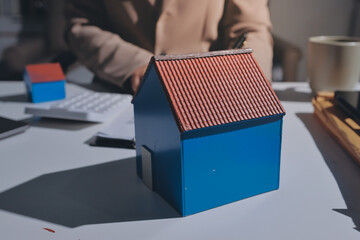 Female Real Estate Broker presenting and advised to .model home and building project detail in the...