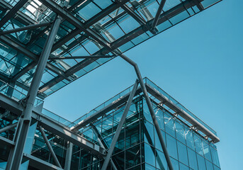 Fototapeta premium Modern Architectural Detail Steel Structure and Glass Facade Against Blue Sky.