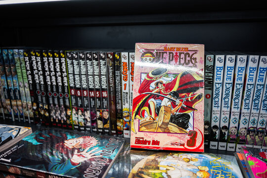 Shelf displaying various manga titles including One Piece and Jujutsu Kaisen volumes