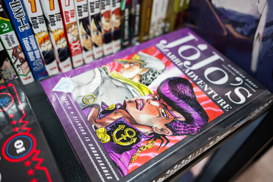 Closeup of manga book JoJo's Bizarre Adventure with other volumes on shelf