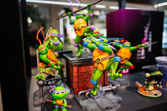Colorful action figure display featuring heroic ninja turtle characters on a shelf. Teenage Mutant Ninja Turtles